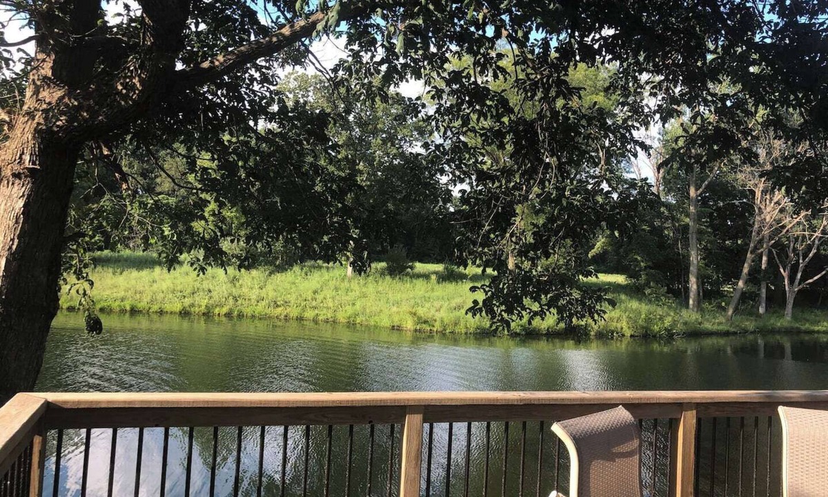 Collinsville House | Escape to a private 3BR waterfront retreat on a 7-acre pond near Route 66. Enjoy peaceful views, a fire pit with seating, fishing dock, and spacious living areas. Perfect for relaxing getaways with easy access to St. Louis attractions.