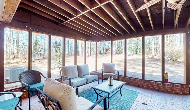 Dog-friendly charmer with large yard, sunroom, game room, grill, AC, & W/D