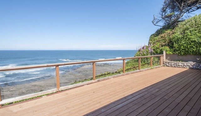 Dramatic oceanfront views. Open high ceilings. Huge deck & walls of windows!