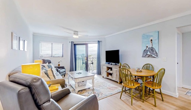 Inviting waterfront condo with marsh view, shared pool, balcony & central AC